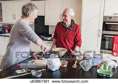 Senior couple preparing pastry View Large Photo Image Stock Image - Senior couple preparing pastry. Fotosearch