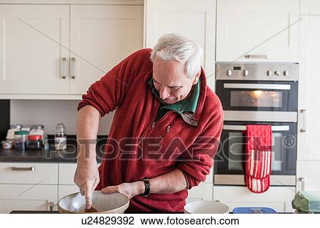Senior male using wooden spoon in mixing bowl View Large Photo Image Stock Image - Senior male using wooden spoon in mixing bowl. Fotosearch