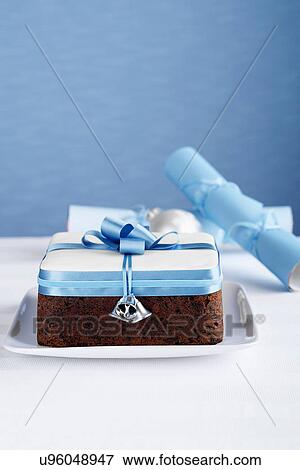 Stock Photo - Square boiled fruitcake with blue bow. Fotosearch
