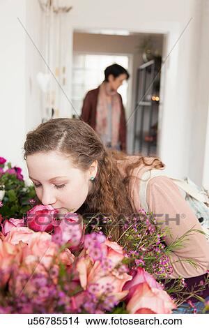 Teenage girl smelling bouquet in florists View Large Photo Image Picture - Teenage girl smelling bouquet in florists. Fotosearch