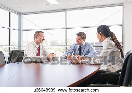 Three business colleagues in office meeting View Large Photo Image Stock Photo - Three business colleagues in office meeting. Fotosearch