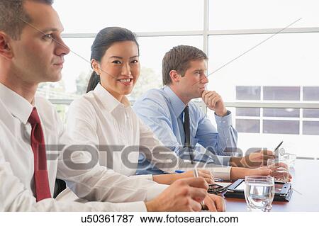 Three business colleagues in office meeting View Large Photo Image Stock Photo - Three business colleagues in office meeting. Fotosearch
