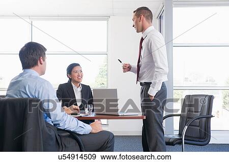 Three business colleagues in office meeting View Large Photo Image Stock Photo - Three business colleagues in office meeting. Fotosearch