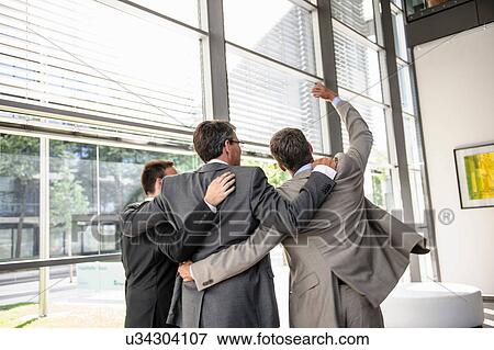 Three businessmen celebrating View Large Photo Image Stock Photo - Three businessmen celebrating. Fotosearch