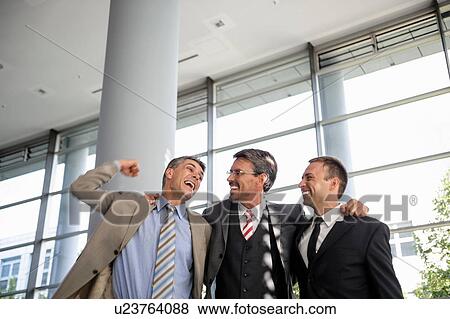 Stock Photo - Three businessmen smiling and celebrating. Fotosearch