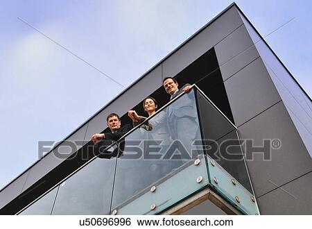 Three office colleagues on balcony, low angle View Large Photo Image Stock Photograph - Three office colleagues on balcony, low angle. Fotosearch