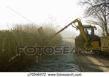 Tractor cutting hedge along country road View Large Photo Image Stock Image - Tractor cutting hedge along country road. Fotosearch