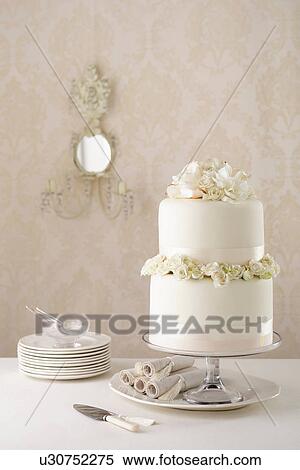 Two tier wedding cake with knife and plates View Large Photo Image Stock Photography - Two tier wedding cake with knife and plates. Fotosearch