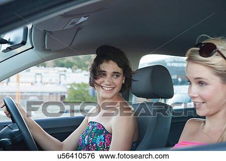Stock Photograph - Two women driving car. Fotosearch