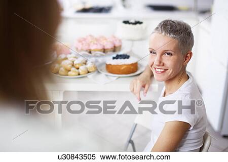 Two women with cakes in background View Large Photo Image Stock Photography - Two women with cakes in background. Fotosearch