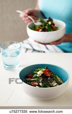 Woman eating vegetable bean salad View Large Photo Image Stock Photography - Woman eating vegetable bean salad. Fotosearch