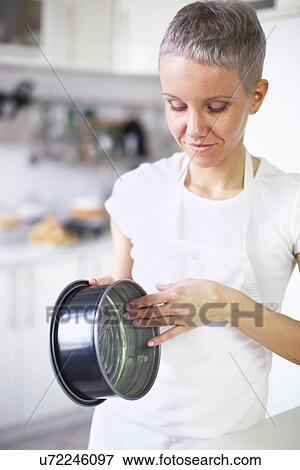 Woman greasing cake tin View Large Photo Image Stock Photo - Woman greasing cake tin. Fotosearch