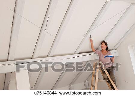 Woman on stepladders painting white ceiling View Large Photo Image Picture - Woman on stepladders painting white ceiling. Fotosearch