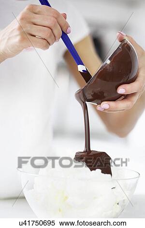 Woman pouring melted chocolate View Large Photo Image Stock Photography - Woman pouring melted chocolate. Fotosearch