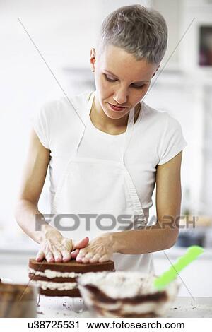 Woman pressing cake View Large Photo Image Stock Image - Woman pressing cake. Fotosearch