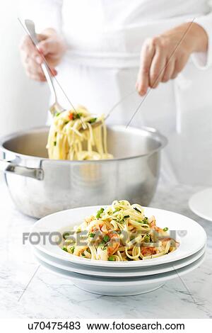 Woman serving linguine View Large Photo Image Stock Image - Woman serving linguine. Fotosearch