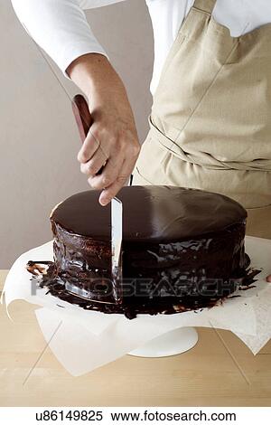 Woman spreading melted chocolate on cake View Large Photo Image Stock Photography - Woman spreading melted chocolate on cake. Fotosearch