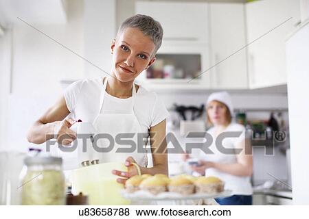 Woman using electric whisk View Large Photo Image Stock Photo - Woman using electric whisk. Fotosearch
