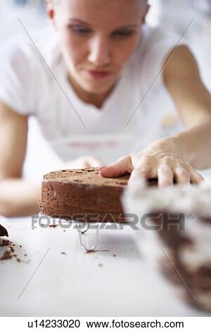 Woman working on cake View Large Photo Image Stock Image - Woman working on cake. Fotosearch