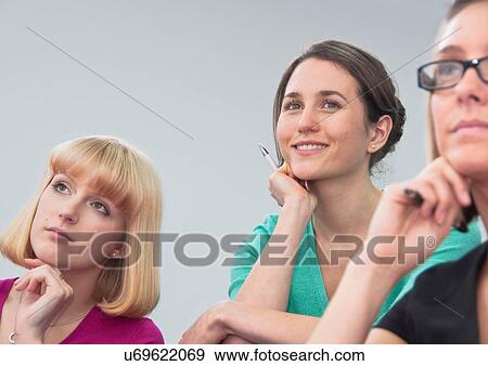 Women listening to presentation View Large Photo Image Stock Photo - Women listening to presentation. Fotosearch