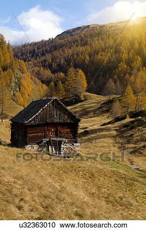 Stock Image - Wooden cabin in Alp Devero, Alpi, Piedmont, Italy. Fotosearch