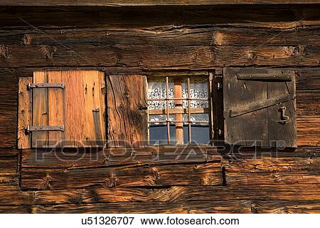 Stock Photo - Wooden shutters open on cabin in Alp Devero, Alpi, Piedmont, Italy. Fotosearch