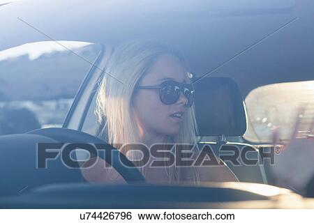 Young blonde women in car wearing sunglasses View Large Photo Image Stock Photograph - Young blonde women in car wearing sunglasses. Fotosearch