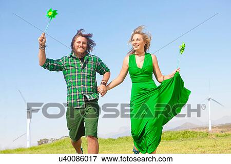 Young couple with pinwheels in filed View Large Photo Image Stock Photo - Young couple with pinwheels in filed. Fotosearch