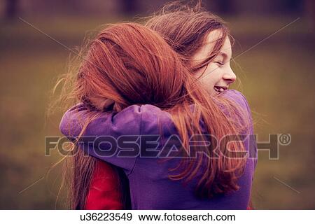 Young friends embracing outdoors View Large Photo Image Stock Photo - Young friends embracing outdoors. Fotosearch