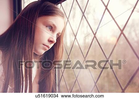 Young girl looking though window View Large Photo Image Picture - Young girl looking though window. Fotosearch