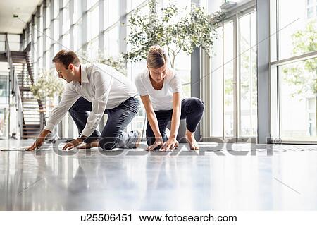 Young woman and mid adult man arranging swatches on lobby floor View Large Photo Image Stock Image - Young woman and mid adult man arranging swatches on lobby floor. Fotosearch