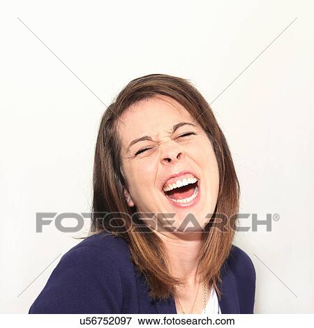 Stock Photo - Young woman laughing against white background. Fotosearch