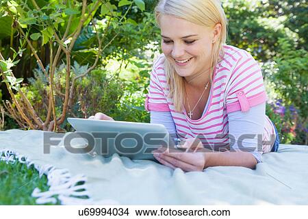 Young woman using digital tablet View Large Photo Image Picture - Young woman using digital tablet. Fotosearch