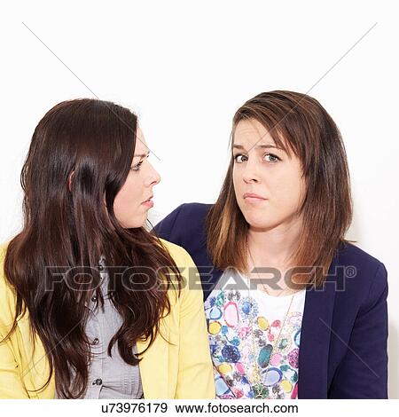 Stock Photo - Young women arguing against white background. Fotosearch