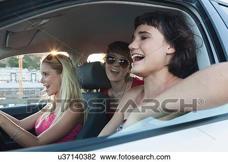 Young women laughing in car View Large Photo Image Stock Image - Young women laughing in car. Fotosearch