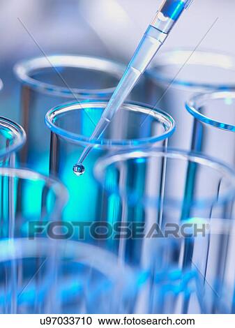 Stock Image - Analytical chemistry - sample being pipetted into test tube for analysis in laboratory. Fotosearch