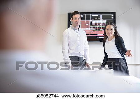 Architects making presentation in boardroom with model building View Large Photo Image Picture - Architects making presentation in boardroom with model building. Fotosearch