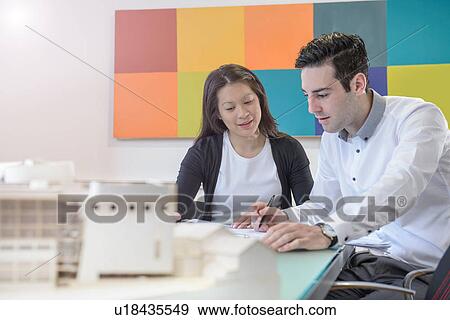 Architects working together in office View Large Photo Image Stock Photo - Architects working together in office. Fotosearch