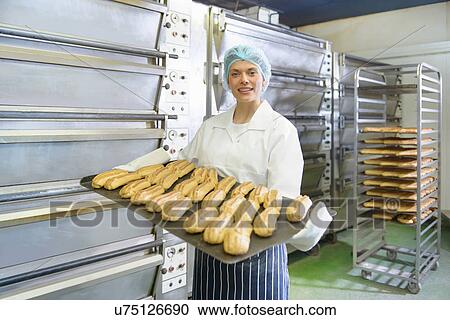 Baker holding tray of baked pastries View Large Photo Image Stock Image - Baker holding tray of baked pastries. Fotosearch