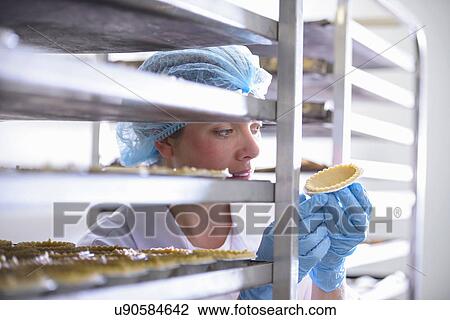 Baker inspecting freshly baked pie case View Large Photo Image Stock Image - Baker inspecting freshly baked pie case. Fotosearch