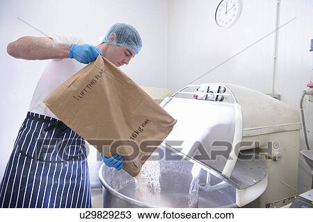 Baker pouring flour from sack into mixer View Large Photo Image Stock Image - Baker pouring flour from sack into mixer. Fotosearch