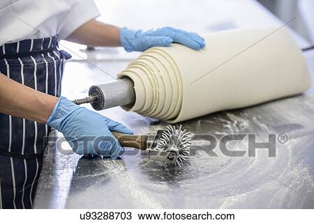 Baker preparing to roll out dough on floury surface View Large Photo Image Stock Image - Baker preparing to roll out dough on floury surface. Fotosearch