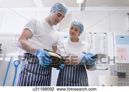 Bakers inspecting freshly baked bread in tin View Large Photo Image Stock Image - Bakers inspecting freshly baked bread in tin. Fotosearch