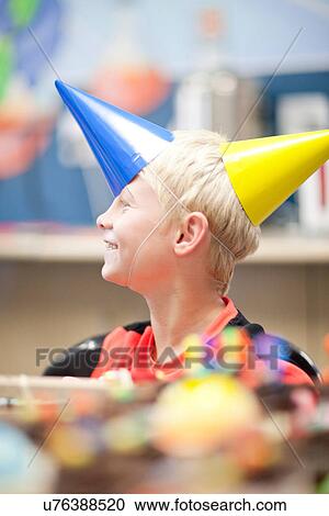 Boy at birthday party wearing two party hats View Large Photo Image Stock Image - Boy at birthday party wearing two party hats. Fotosearch