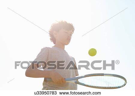 Boy bouncing ball on tennis racket View Large Photo Image Stock Image - Boy bouncing ball on tennis racket. Fotosearch