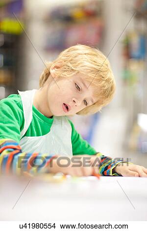 Picture - Boy concentrating on drawing. Fotosearch