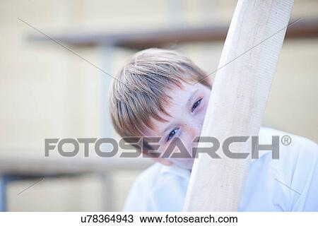 Boy holding cricket bat in front of face View Large Photo Image Stock Image - Boy holding cricket bat in front of face. Fotosearch