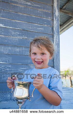 Boy holding trophy View Large Photo Image Stock Photo - Boy holding trophy. Fotosearch