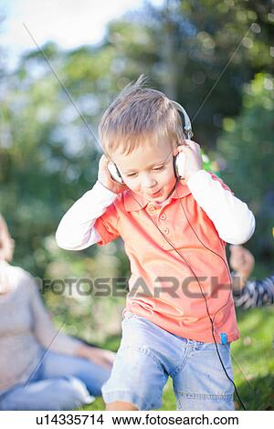 Boy listening to music outdoors View Large Photo Image Picture - Boy listening to music outdoors. Fotosearch