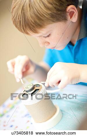 Boy making craft object View Large Photo Image Stock Photo - Boy making craft object. Fotosearch